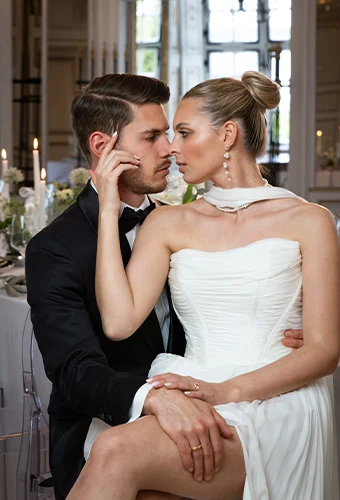 Bride wearing All Who Wander avalon, an etheral strapless a-line wedding gown, featuring statement earrings