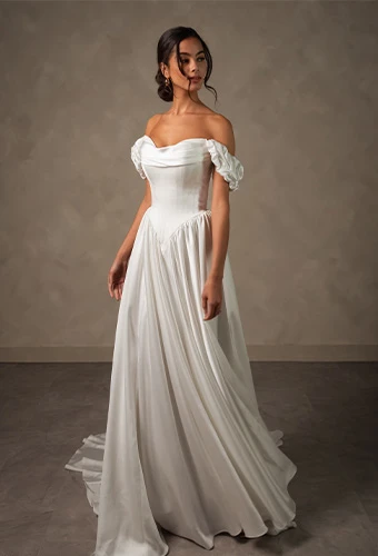 Bride wearing satin a line wedding dress with sweetheart neckline and off the shoulder puff sleeves