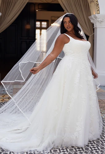 Bride wearing Essense of Australia style D4620+, a plus size lace a-line wedding dress with square neckline and tulle skirt