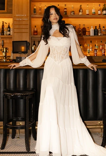 Bride wearing All Who Wander dalton, a lace and chiffon a-line wedding gown with high neck and tiered skirt