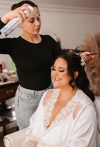 Bride getting her hair set with hairspray