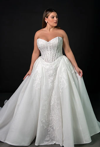 Plus size bride wearing strapless lace ballgown wedding dress with sweetheart neckline