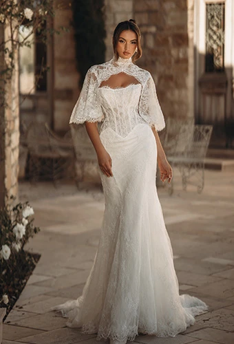 Bride wearing Martina Liana style ML2010, a lace and tulle fit-and-flare wedding gown with removable high-neck cape