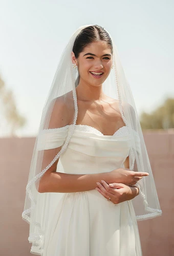 Bride wearing SY8236, a satin wedding dress with a-line silhouette and pearl sweetheart neckline, paired with a fingertip veil