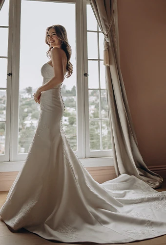 Bride wearing Stella York style SY8251, a mikado mermaid wedding gown with strapless neckline