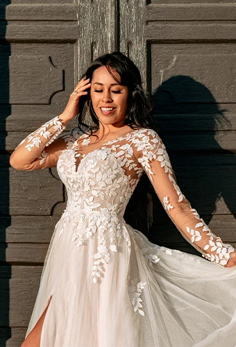 Bride wearing lace wedding dress with long sleeves