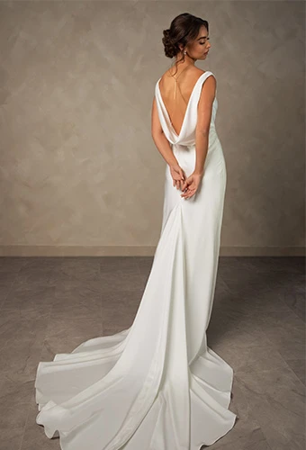Bride wearing simple column wedding gown with cowl back detail