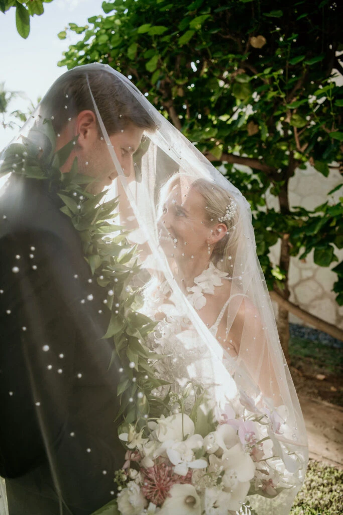 True bride Erin posing with her husband under her veil