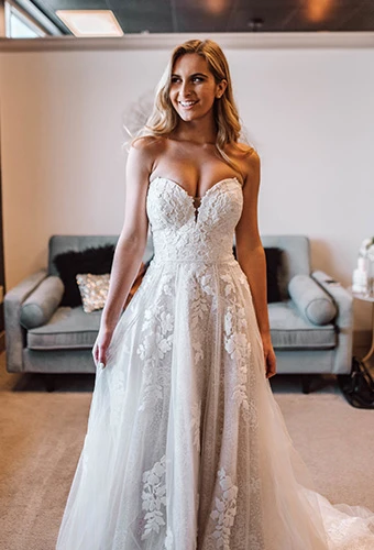 Bride wearing strapless cotton lace wedding dress with sweetheart neckline