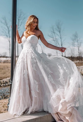Bride wearing strapless lace wedding dress with sweetheart neckline