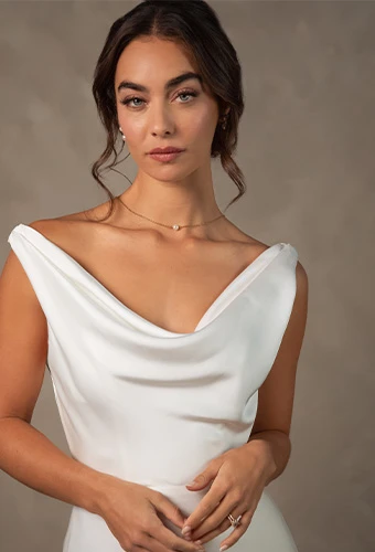 Bride wearing simple wedding gown with cowl neckline