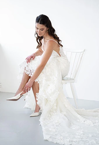 Bride putting on her wedding shoes