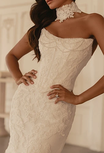 Bride wearing strapless wedding gown with beaded lace