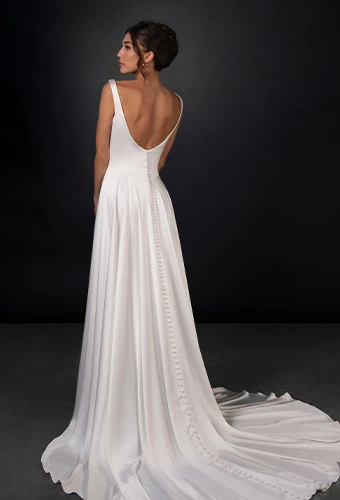 Bride wearing simple wedding gown with scoop back