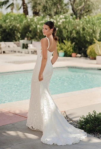 Bride wearing allover leafy lace wedding dress with sheer cutouts and a court train, Stella York sy8253