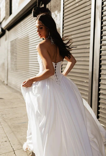 Bride wearing simple a line wedding gown with lace up back
