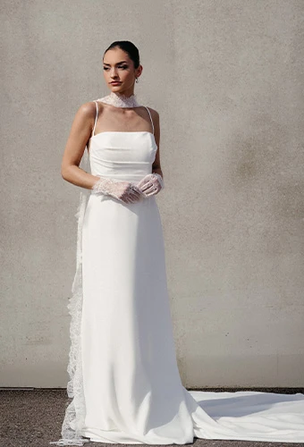 bride wearing simple wedding gown with straight across nckline and spaghetti straps