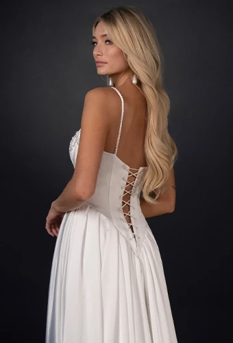 Bride wearing a line wedding dress with spaghetti straps and corset back