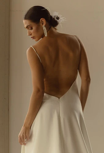 Bride wearing simple wedding dress with open back