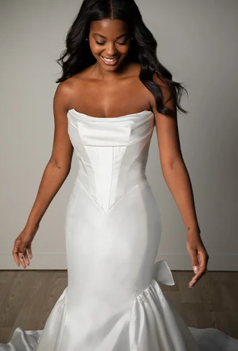 Bride wering strapless wedding dress with bow details