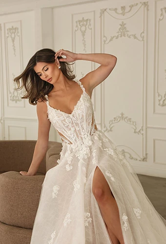 Bride wearing floral A-line wedding dress with illusion tulle side cutouts and open back, Martina Liana ML1899