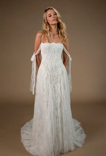 Bride wearing lace a line wedding dress with straight across neckline and off the shoulder straps