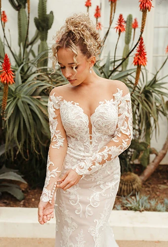 Bride wearing floral lace fit-and-flare wedding dress with illusion tulle neckline and sleeves, Stella York SY8162