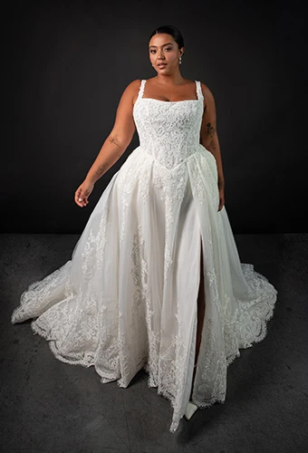 Plus size bride wearing lace and tulle ballgown with lace-hemmed train and bow details, Martina Liana ML2041+