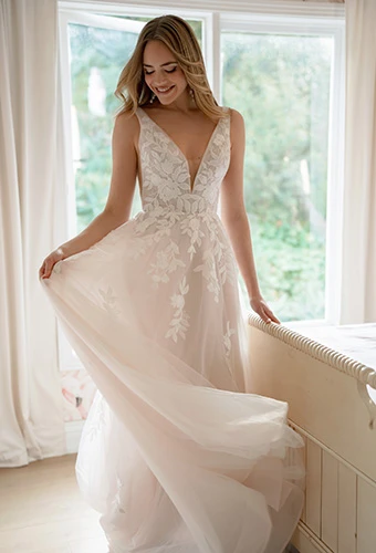 Bride wearing lace and tulle A-line wedding dress with large floral cascading appliqués, Stella York SY8316