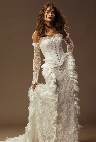 Bride wearing strapless lace wedding gown with detachable sleeves