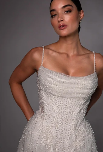 Bride wearing pearl beaded wedding gown with spaghetti straps