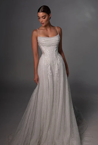 Bride wearing a line wedding dress with pearl beading and spaghetti straps