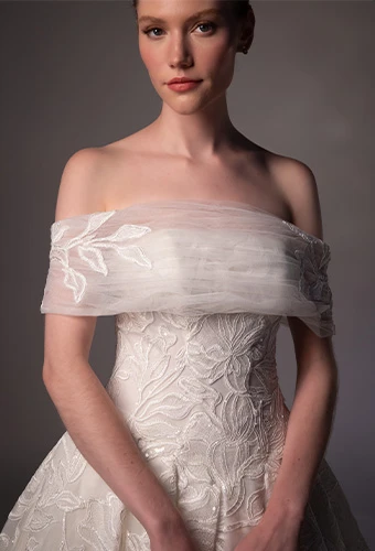 Bride wearing lace ballgown wedding dress with optional shawl