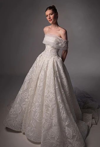 Bride wearing lace ballgown wedding dress with optional shawl and straight across neckline