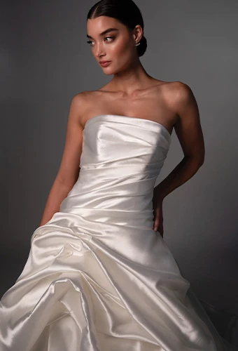 Bride waring strapless wedding gown with straight across neckline