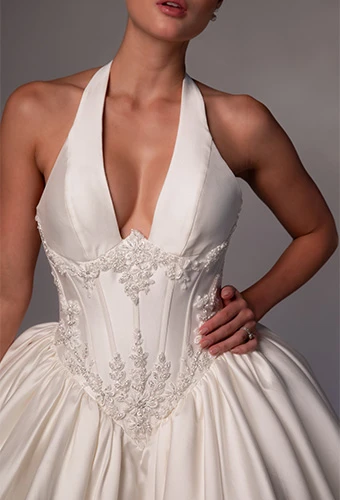 Bride wearing halter neckline ballgown wedding dress with basque waist