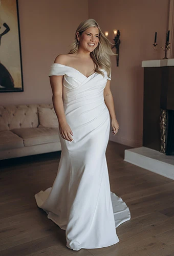 Bride wearing plus size crepe wedding dress with off-shoulder straps, Stella York SY8330+
