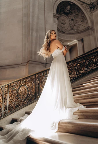 Bride wearing shimmering tulle fit-and-flare wedding dress with overskirt, Stella York SY7815