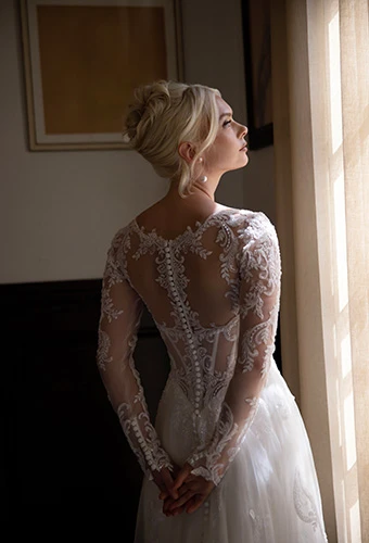 Back of A-line wedding dress with floral lace long sleeves and soft tulle illusion open back, Essense of Australia D4577