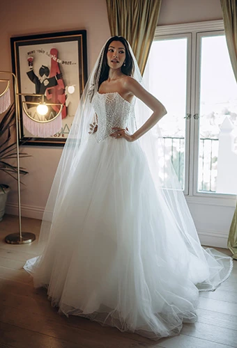 Bride wearing A-line tulle wedding dress with strapless beaded bodice, Stella York SY8312
