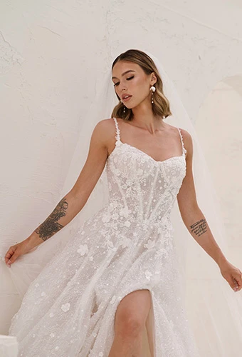 Bride wearing shimmering tulle A-line wedding dress with 3D florals and corset bodice, Martina Liana ML1831