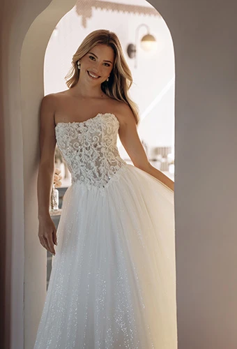 Bride wearing strapless sparkle tulle A-line wedding dress with lace corset, Stella York SY8301